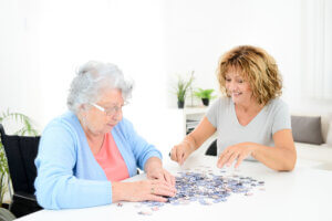 Senior women with dementia engaging in puzzle activity