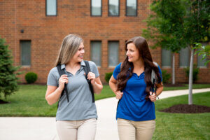 Physical therapy students walking and talking on campus