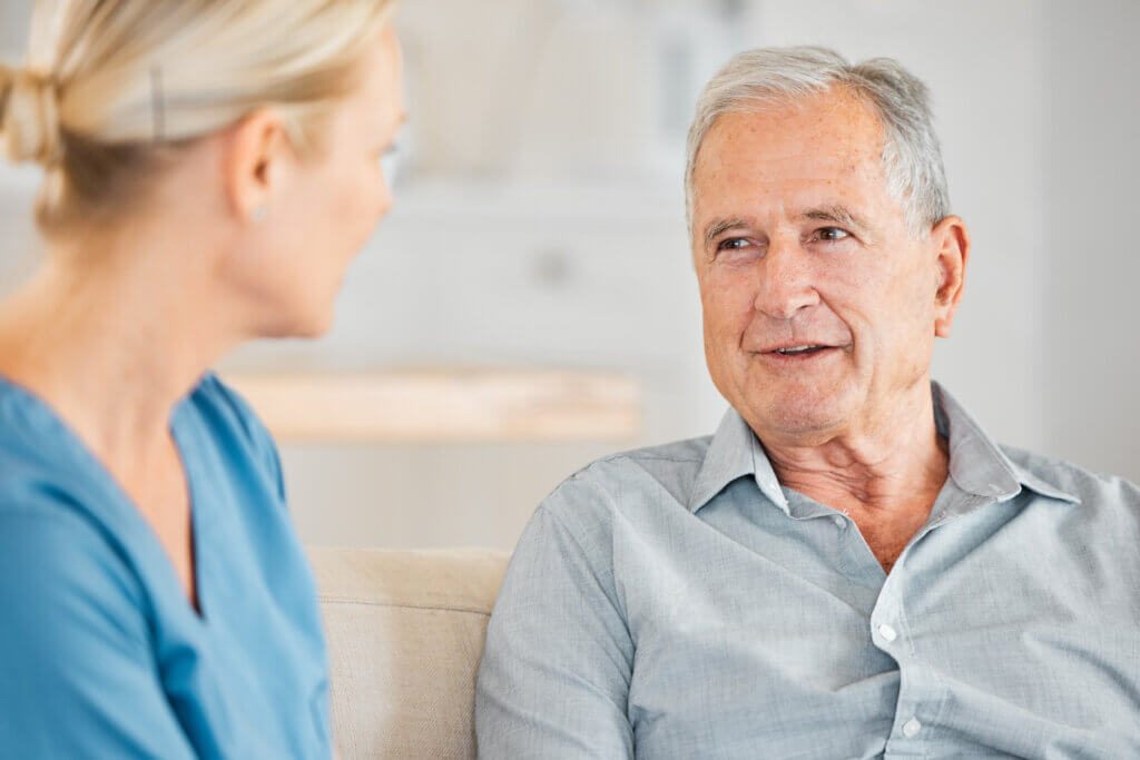 Therapist converses with a male resident, showcasing how to communicate with someone with dementia.