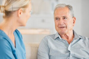 Therapist converses with a male resident, showcasing how to communicate with someone with dementia.