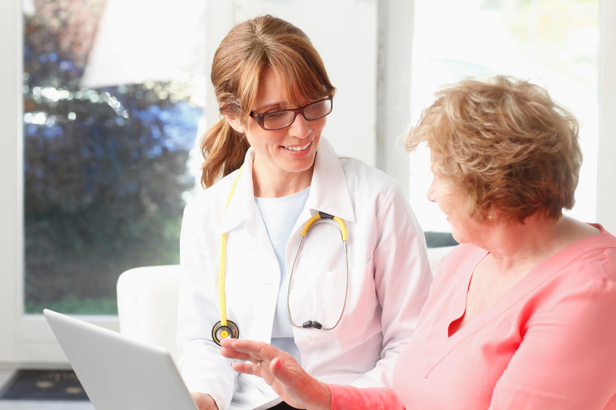 Female nurse practitioner consulting with senior patient.