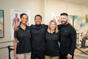 Clinic Director standing with their therapy team, showcasing collaboration and leadership in a healthcare setting