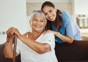 Caregiver helping senior woman with demantia or alzheimer disease