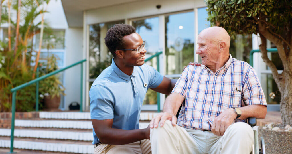Therapist conducting mental health assessment on male senior.