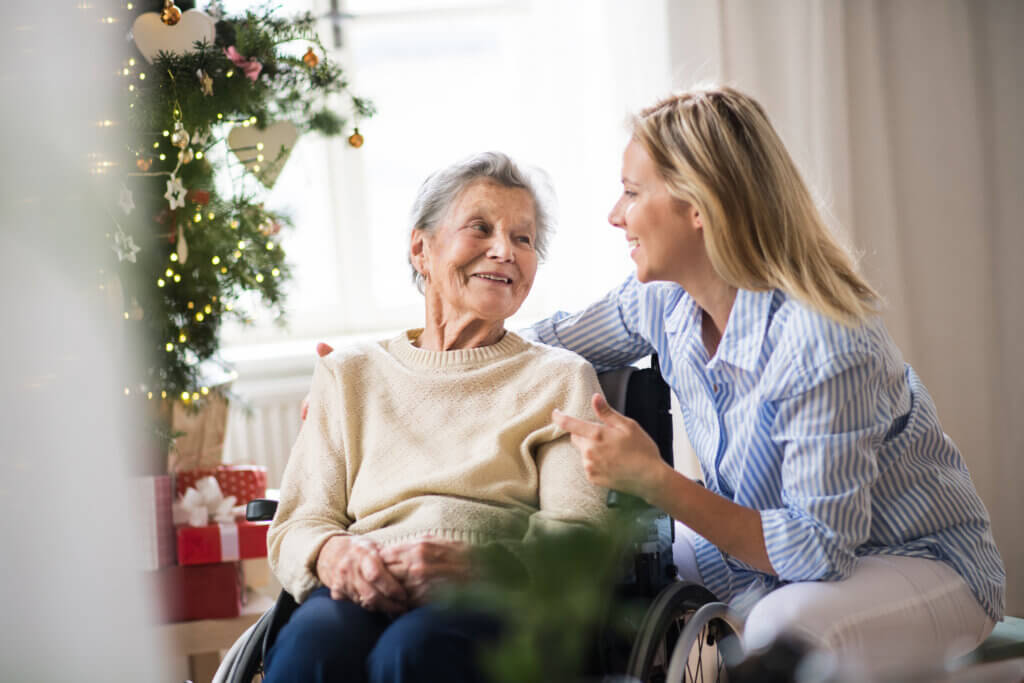 A senior woman with a therapist at Christmas time, talking.