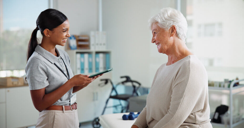 Physiotherapy, tablet and happy woman with mature patient with medical results, consulting and mobility
